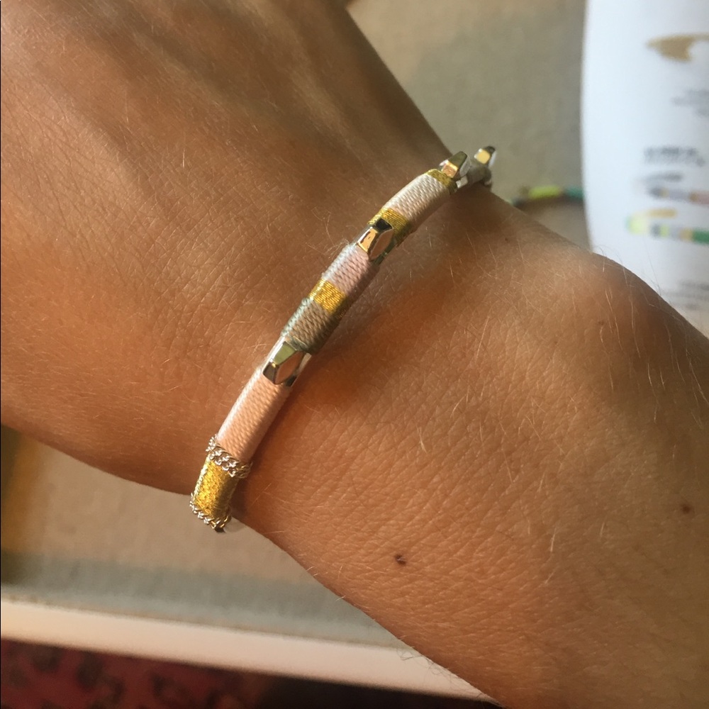 Silver bracelet with colored thread detail